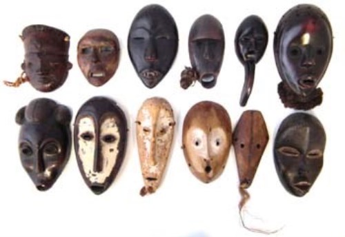 Lot 11 - Twelve African passport masks carved in various tribal styles, the largest measures 19cm high