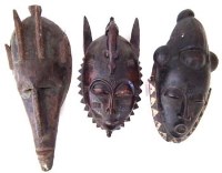 Lot 20 - Two Guro - Yaure masks and a Warka metal mounted