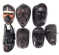 Lot 27 - Seven African masks carved in various tribal styles, the largest measures 29cm high