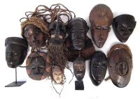 Lot 70 - Eleven African masks carved in various tribal