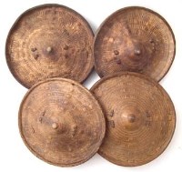 Lot 97 - Four Somalian circular tooled hide parrying shields, 32cm diameter