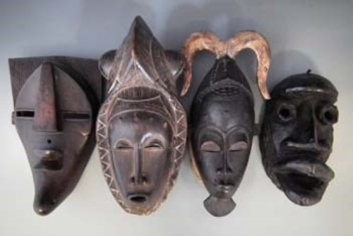 Lot 41 - Four masks, carved in Bete, Guro, Yaure, and Lulua tribal styles, the largest measures 42cm high