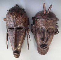 Lot 42 - Two Marka metal mounted masks, 34cm high     All