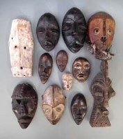 Lot 54 - Twelve African passport masks carved in various