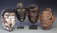 Lot 61 - Four Makonde type face masks, the tallest