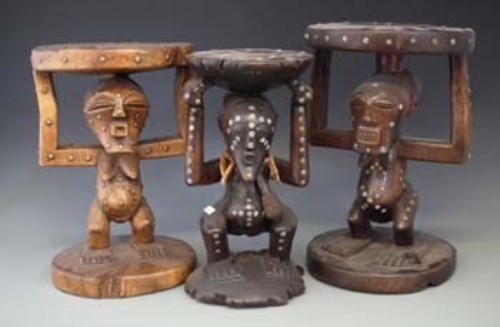 Lot 79 - Three Songye caryatid stools carved with nkisi