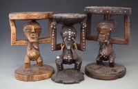 Lot 79 - Three Songye caryatid stools carved with nkisi