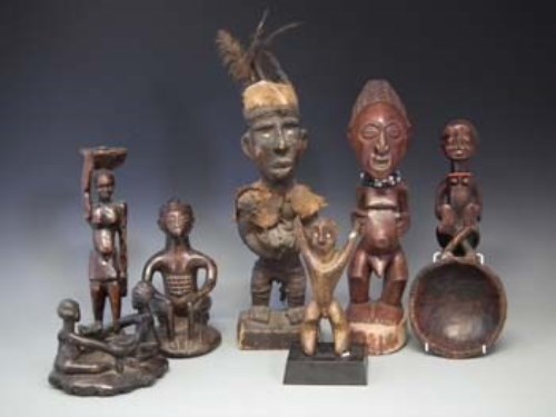 Lot 104 - Six African figures and a spoon, carved in