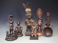 Lot 104 - Six African figures and a spoon, carved in