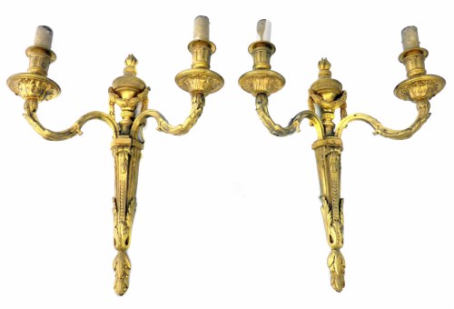 Lot 12 - A pair of late 19th century gilt brass twin branch wall lights