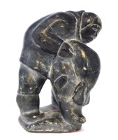 Lot 44 - Carved soapstone figure of an innuit holding a