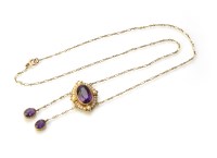 Lot 189 - An Edwardian amethyst and seed pearl cluster double drop pendant and chain