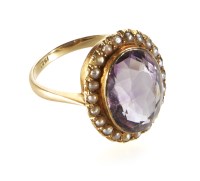 Lot 196 - Amethyst and seed pearl oval cluster 15ct yellow gold ring