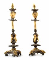 Lot 29 - A pair of bronze candlesticks