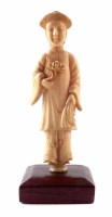 Lot 172 - 19th century Chinese carved ivory figure in long robe holding single flower stem