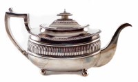 Lot 181 - George III silver teapot by William Bennett, rounded rectangular body with fluted decoration on four ball feet, harp-shaped handle, gross weight 655g