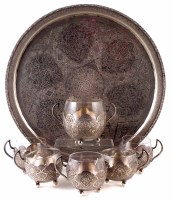 Lot 188 - A Turkish circular silver tray, decorated with intricate floral designs and scrollwork, inset with various scenes depicting warriors, farmers, dancers