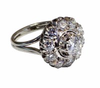 Lot 210 - 18ct white gold diamond flower head cluster ring, 0.51ct central brilliant cut diamond in raised claw settings surrounded by 10 smaller brilliant cut