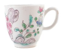 Lot 84 - Bow good coffee cup painted in famille rose style with chrysanthemum and holed rocks c. 1755.