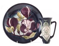 Lot 283 - Moorcroft twin handled vase and a charger.