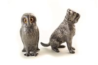 Lot 160 - Early 20th century pewter pepperette in the form of an owl with amber glass eyes and another pewter pepperette in the form of a dog. 9 and 9.5cm height respectively.