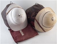 Lot 89 - Two pithe helmets in tins