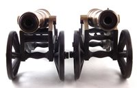 Lot 18 - Two similar bronze model cannons on cast iron bases