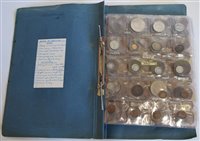 Lot 23 - Two large albums of British and foreign world coins and tokens.