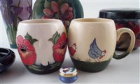 Lot 233 - Moorcroft pomegranate box, two bowls , two mugs and an enamels box also a Dennis vase