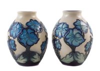 Lot 245 - Matched pair of Moorcroft vases, decorated with blue as the sky pattern (2) 13cm high