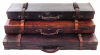 Lot 167 - Leather double gun case William Powell and Son, single Westley Richards case and Leather on oak case.